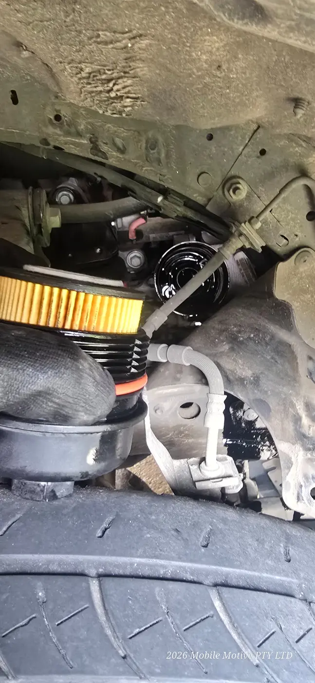 Oil filter replacement during a Mobile Motive vehicle service and safety inspection