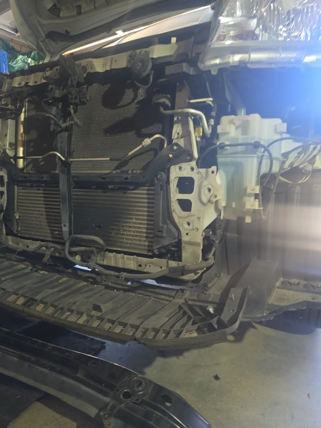Vehicle radiator and cooling pack exposed during cooling system repair by Mobile Motive