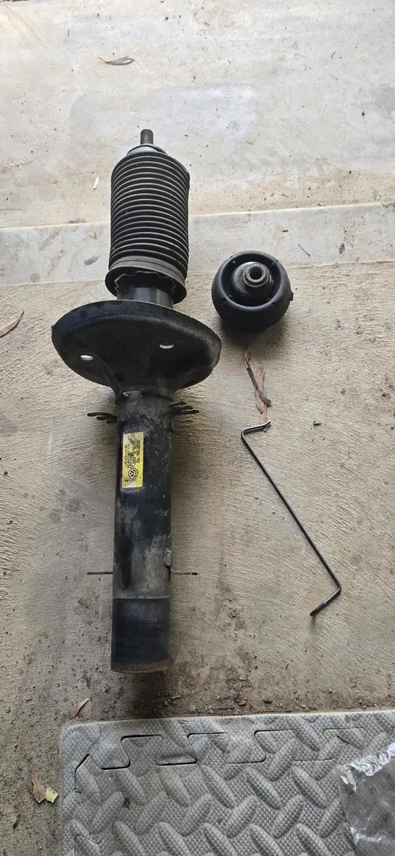 Removed suspension strut inspected during mobile mechanical work